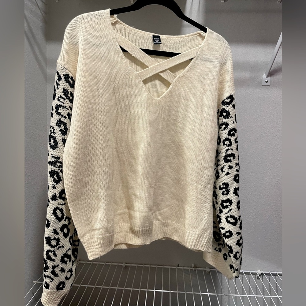 beige cross-cross front sweater with black leopard print detail sleeves